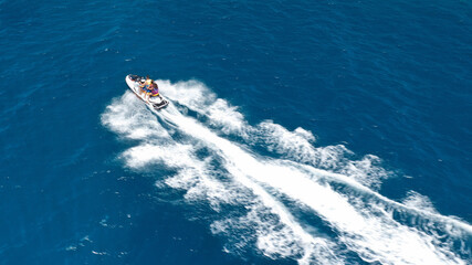 defaultAerial drone photo of stunt man performing extreme stunts with water craft over the ocean at dusk