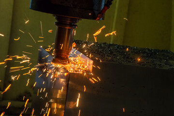 The burning chip from CNC milling machine rough cutting  by index-able  end-mill tools. The...