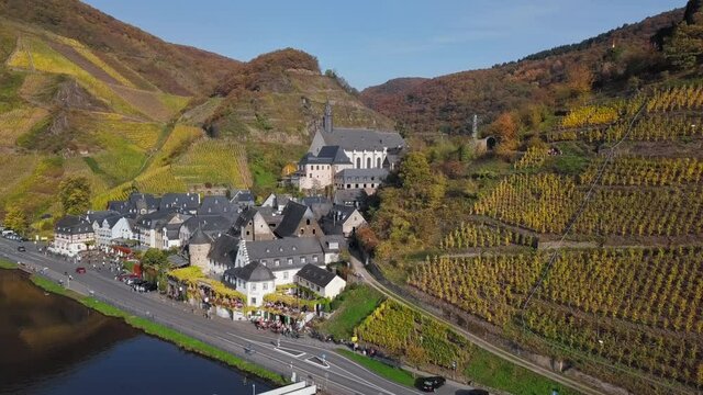 Flight over of Beilstein town and autumn vineyards, Mosel valley, Germany.