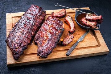 Barbecue pork spare loin ribs St Louis cut with hot honey chili marinade burnt as closeup on a...