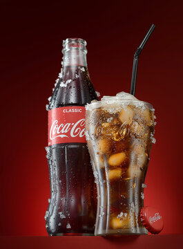 POLTAVA, UKRAINE - February 10, 2019: Glass of coca cola and bottle on a dark background