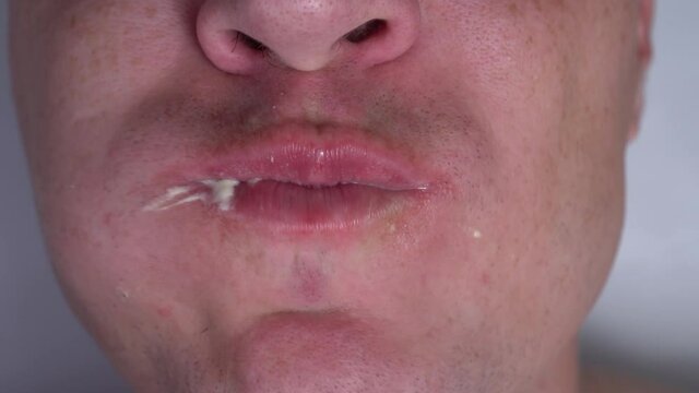 close-up of the face. man eats a noxious dirgy burger. junk food fast food
