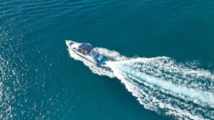 Aerial drone ultra wide photo of rigid inflatable speed boat cruising in deep blue Aegean sea,...