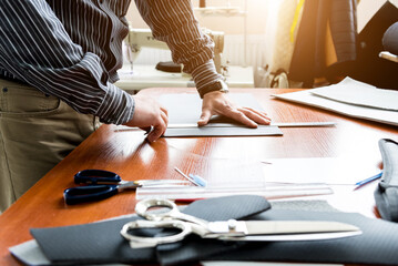 Designer tailor sew seat covers. Man use sewing machine for his work.