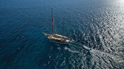 Fototapeta premium Aerial drone photo of beautiful wooden deck classic sailing yacht cruising in open ocean deep blue sea