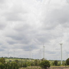 Fototapeta na wymiar Wind Turbine Energy and Agriculture Farm in Cloudy Day
