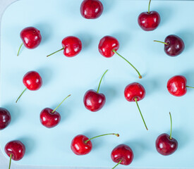 Cherry on blue background. Ripe ripe cherries. Sweet red cherries. Top view. Rustic style. Fruit Background