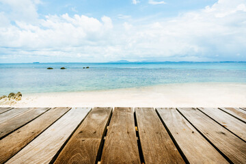 Fototapeta na wymiar Top of wood table with seascape and blue sky