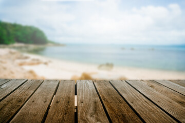 Fototapeta na wymiar Top of wood table with seascape and blue sky