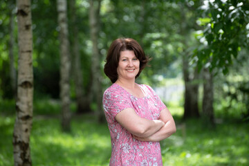 Woman in a pink dress in a summer park