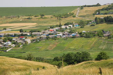 Fototapeta na wymiar Beautiful view of a Russian village from the hill. Lovely little houses.