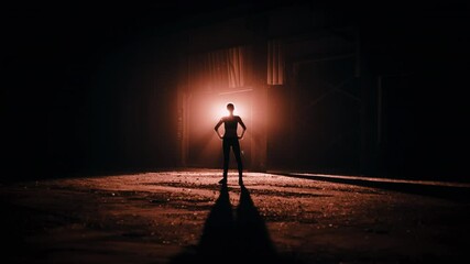 Silhouette of woman standing in a deserted building