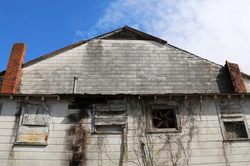 Fototapeta na wymiar abandoned dilapidated weathered old factory warehouse building