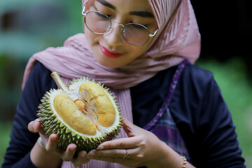 Asia woman holding durian fruit