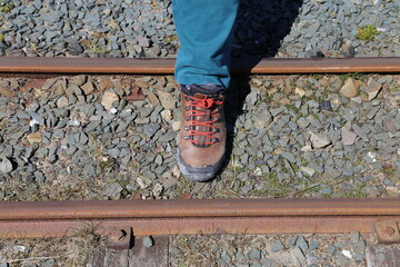 A narrow gauge railway line with a shoe for comparative size.
