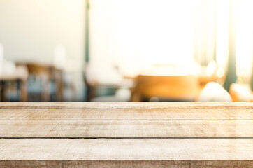 Empty wooden top table with blur coffee shop background