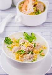 Shrimp porridge white bowl on wooden background