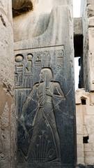 Karnak temple luxor with Egyptian hieroglyphic on granite sculture stone base showing fat man with...