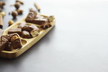 Chocolate bars on a black background in backlight. Chocolate with filling. Sweet sweets for snack and tea.