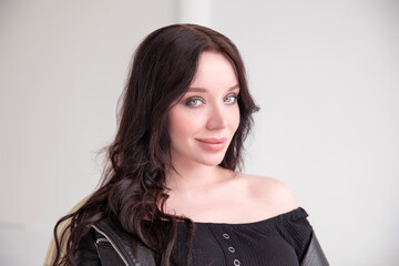 Obraz premium large portrait of a beautiful white young brunette girl against a white background