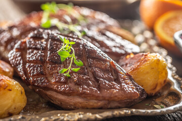 Detail of tasty roasted duck breasts and potatoes on a vintage plate