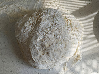 Fresh whole grain flour dough lies on the table. Black and white drawing. Instructions, step 1. Mobile photo.