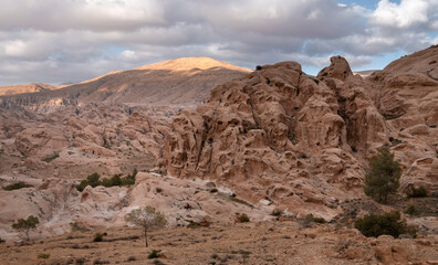 cliffs of light limestone in the desert mountains near the city of Wadi Musa in the Petra National Park in Jordan in.spring day
