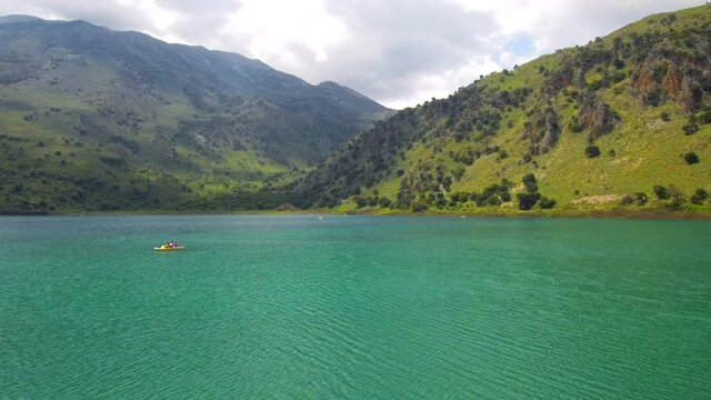 Flying above a Lake with mountains on the background at Crete Island