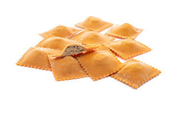 Fresh ravioli pasta colored with paprika and meat topping isolated on a white background