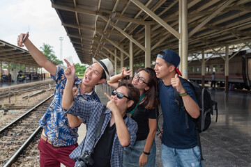 Fototapeta premium Concept life style holidays travel or journey : Young Asian tourists friend group Are using mobile phones for selfies at Train station area
