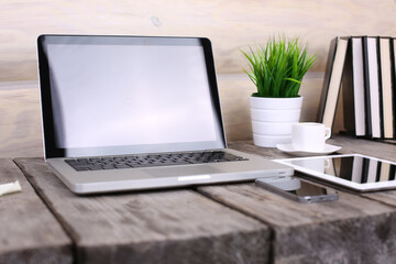 Stylish workspace with computer and posters on home or studio