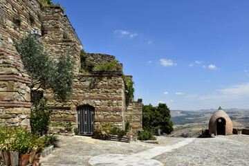 A small square among the ruins of ancient buildings in the medieval town of Cairano in the province of Avellino, Italy.