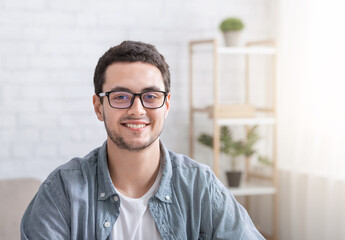 Education conference or work from home. Smiling guy in interior of living room