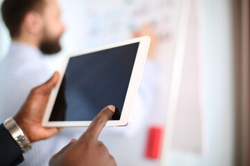 Mock up of a man holding digital tablet device in hands.