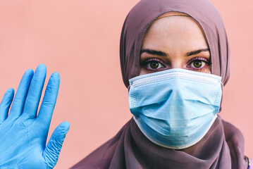 Muslim Woman with Surgical Face Mask and glove
