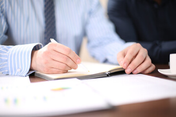 business people and lawyers discussing contract papers sitting at the table. Concepts of law, advice, legal services.