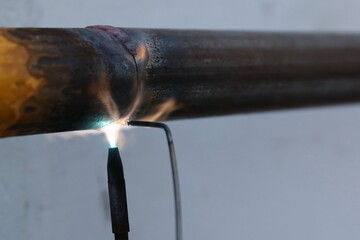 welding metal pipe by acetylene gas burner close up