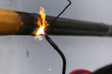 welding metal pipe by acetylene gas burner close up