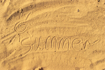 Summer text handwritten in a beach sand