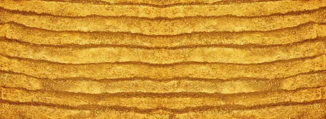 Gold powder wide texture. Golden colored sand dust widescreen large background