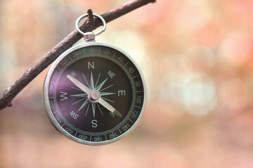 round compass on red abstract background as symbol of tourism with compass, travel with compass and outdoor activities with compass