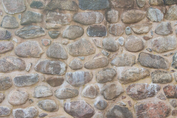 Ancient fortress stone wall. Natural background or texture. Front view.
