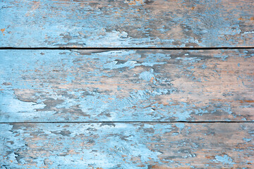 aged wooden plank background with peeling blue paint