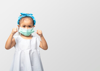 A girl wearing a mask to protect the COVID-19 virus.