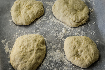 Raw little focaccia dough balls ready to be backed. Traditional Italian Focaccia homemade flat bread focaccia.