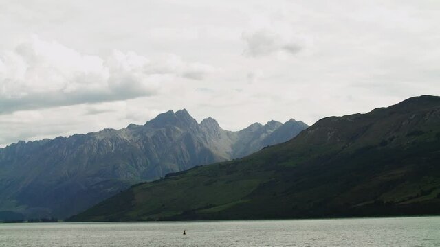 steady shot of typical paining like new zealand landscape with wam sunlight on the mountain and snow eak and the lake .mov