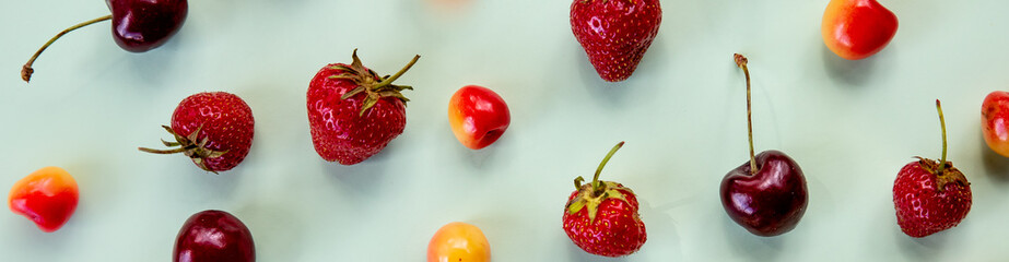 Colorful bright pattern with ripe cherry and strawberries. fresh summer berries. berry seamless pattern, strawberry and colorful cherries on pastel background.banner for website.Minimal fruit concept