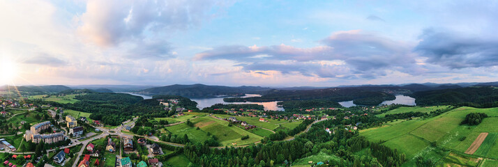Aerial panorama of Solina lake in Polanczyk, Bieszczady Mountains. Popular travel destination in south-eastern Poland. Sunset during summer days.