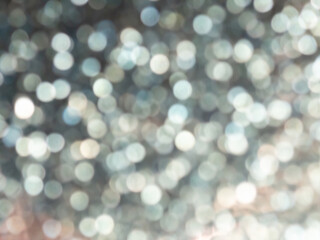 Abstract colorful grey and silver small bokeh Look bright effect texture on black background. glitter vintage lights defocused elegant for cosmetics or celebrate. Sparkling magical dust particles.