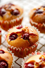 Homemade cherry muffins on a cooling tray close-up view